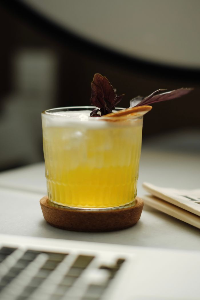 A chilled yellow cocktail with ice and garnish served indoors on a tabletop in Istanbul.